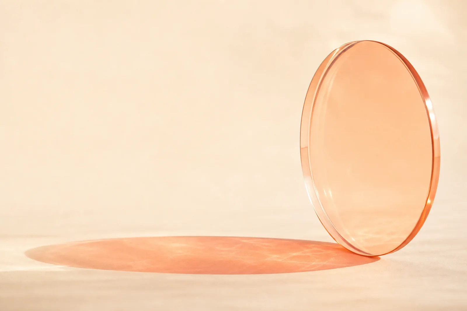 Premium warm glass website background with a translucent apricot lens, coral shadow, and cream copy area