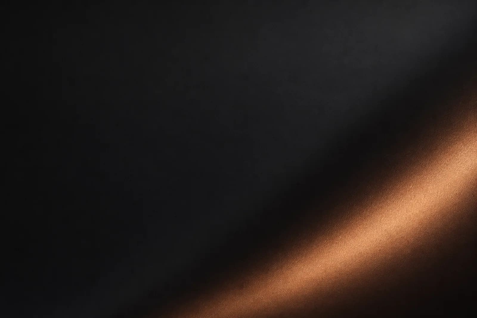 Dark material website background with graphite satin grain, a restrained copper reflection, and quiet left copy space